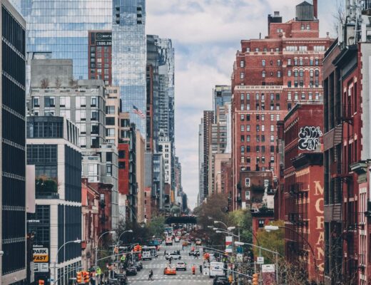 vehicles on road between high rise buildings