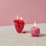 photograph of a heart candle beside a brain candle